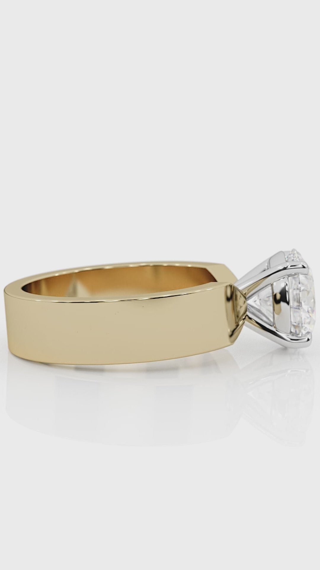 Close-up of a custom engagement ring by lessard coutu jewellery called Fièrté featuring highly detailed yellow gold handcrafted band and a brilliant diamond set in a delicate, handcrafted band.