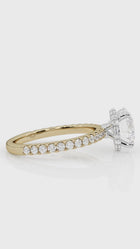 Close-up of a custom engagement ring by lessard coutu jewellery called La Classique featuring highly detailed yellow gold handcrafted band and a brilliant diamond set in a delicate, handcrafted band.